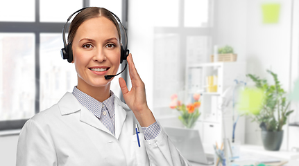 Image showing smiling female doctor with headset at hospital