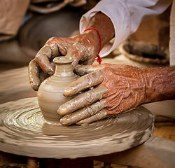 Image showing Potter at work makes ceramic dishes. India, Rajasthan.