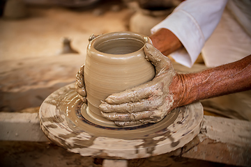 Image showing Potter at work makes ceramic dishes. India, Rajasthan.