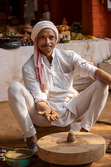 Image showing Potter at work makes ceramic dishes. India, Rajasthan.