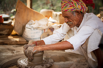 Image showing Potter at work makes ceramic dishes. India, Rajasthan.