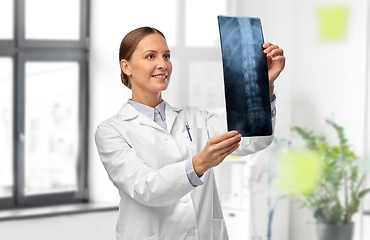 Image showing female doctor with x-ray of spine at hospital