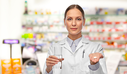 Image showing female doctor with medicine and glass of water