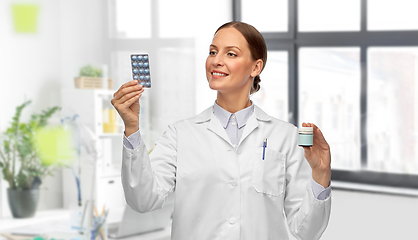 Image showing female doctor holding medicine pills at hospital