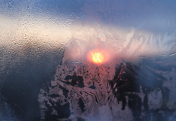 Image showing Ice pattern and water drops on glass on a sunny winter morning