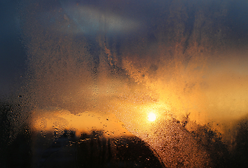 Image showing Melting ice, water drops and sunlight in a winter morning on gla