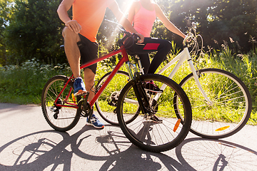 Image showing young couple riding bicycles outdoors