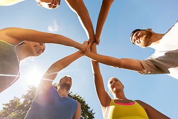 Image showing group of happy sporty friends making high five