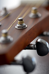 Image showing close up of acoustic guitar head with pegs