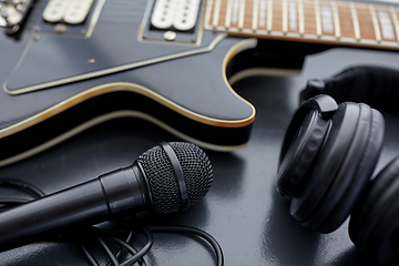 Image showing close up of bass guitar, microphone and headphones