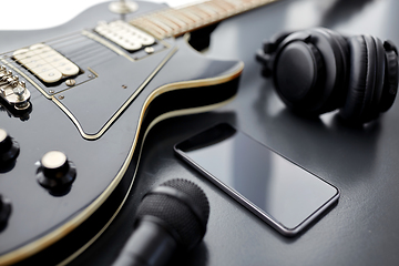 Image showing close up of bass guitar and smartphone