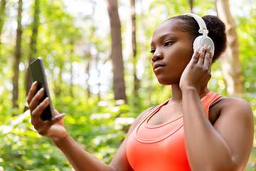 Image showing african american woman with headphones and phone