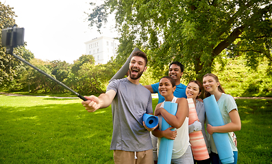 Image showing people with yoga mats taking selfie at park