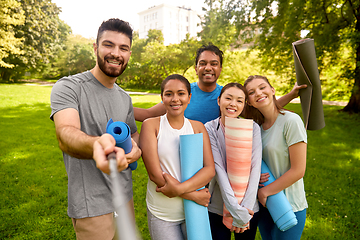 Image showing people with yoga mats taking selfie at park