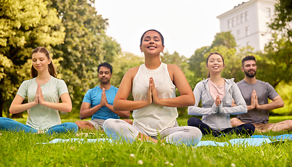 Image showing group of people doing yoga at summer park