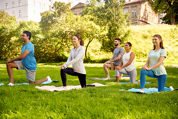 Image showing group of people doing yoga at summer park