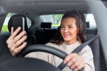 Image showing woman or driver driving car and taking selfie