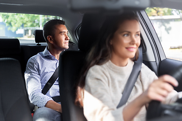 Image showing female driver driving car with male passenger