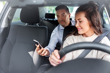 Image showing female driver driving car with male passenger