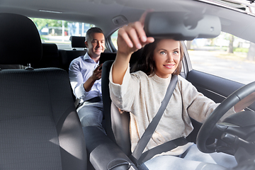 Image showing female driver driving car with male passenger