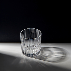 Image showing empty faceted glass on table