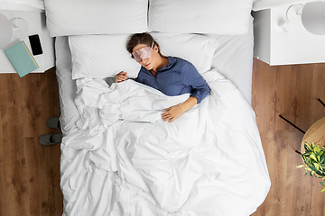 Image showing young woman in mask sleeping in bed at home