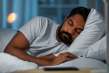 Image showing indian man sleeping in bed at home at night