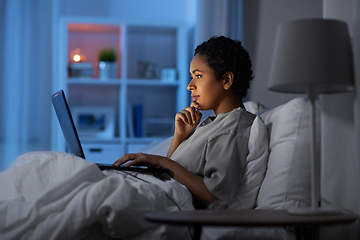 Image showing woman with laptop in bed at home at night