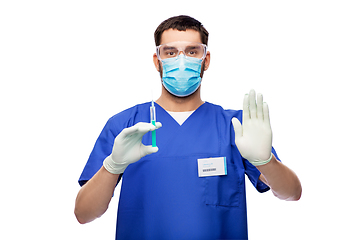 Image showing male doctor in mask and gloves with syringe