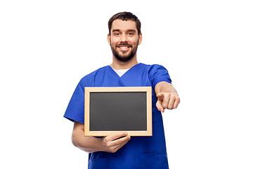 Image showing happy smiling male doctor or nurse with chalkboard