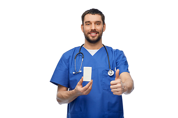 Image showing male doctor with medicine showing thumbs up