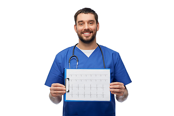 Image showing smiling male doctor with cardiogram on clipboard