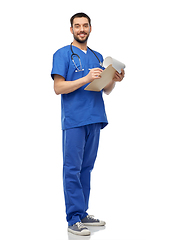 Image showing male doctor writing medical report on clipboard