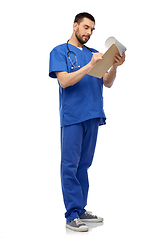 Image showing male doctor writing medical report on clipboard