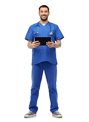 Image showing smiling doctor or male nurse using tablet computer