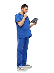 Image showing doctor or male nurse using tablet computer