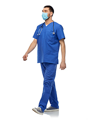 Image showing male doctor in blue uniform and mask walking