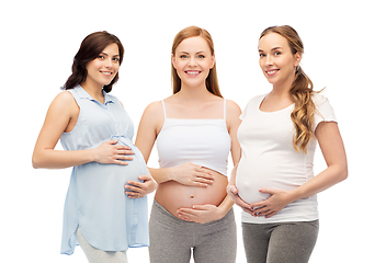 Image showing happy pregnant women touching their big bellies