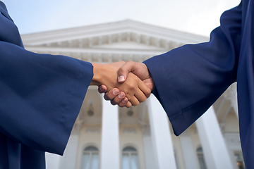 Image showing handshake of graduate students or bachelors