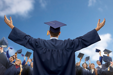 Image showing happy students or bachelors waving mortar boards