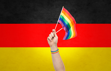 Image showing hand with gay pride rainbow flags and wristband