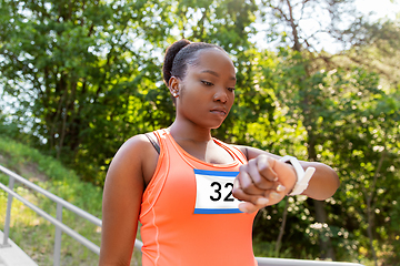 Image showing african female marathon runner with smart watch