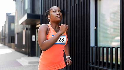 Image showing young african american woman running marathon