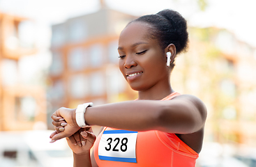 Image showing marathon runner with earphones and smart watch