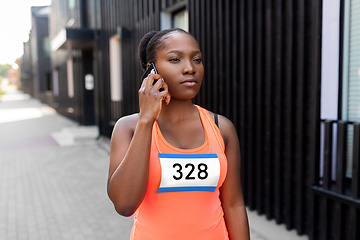 Image showing female marathon runner calling on smartphone