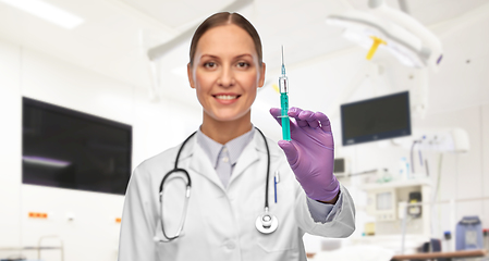 Image showing female doctor with medicine in syringe at hospital