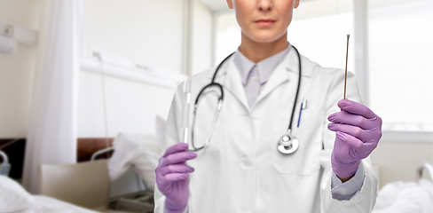 Image showing female doctor with cotton swab and test tube