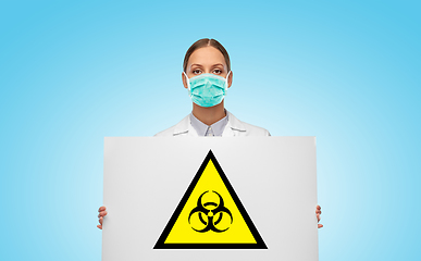 Image showing female doctor in mask with biohazard sign