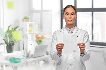 Image showing female doctor with prescription blank at hospital