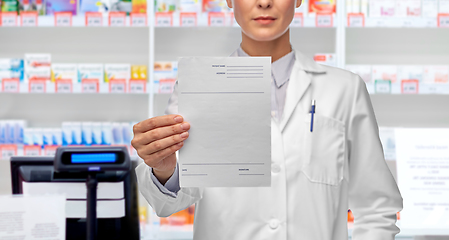 Image showing close up of female doctor with prescription blank